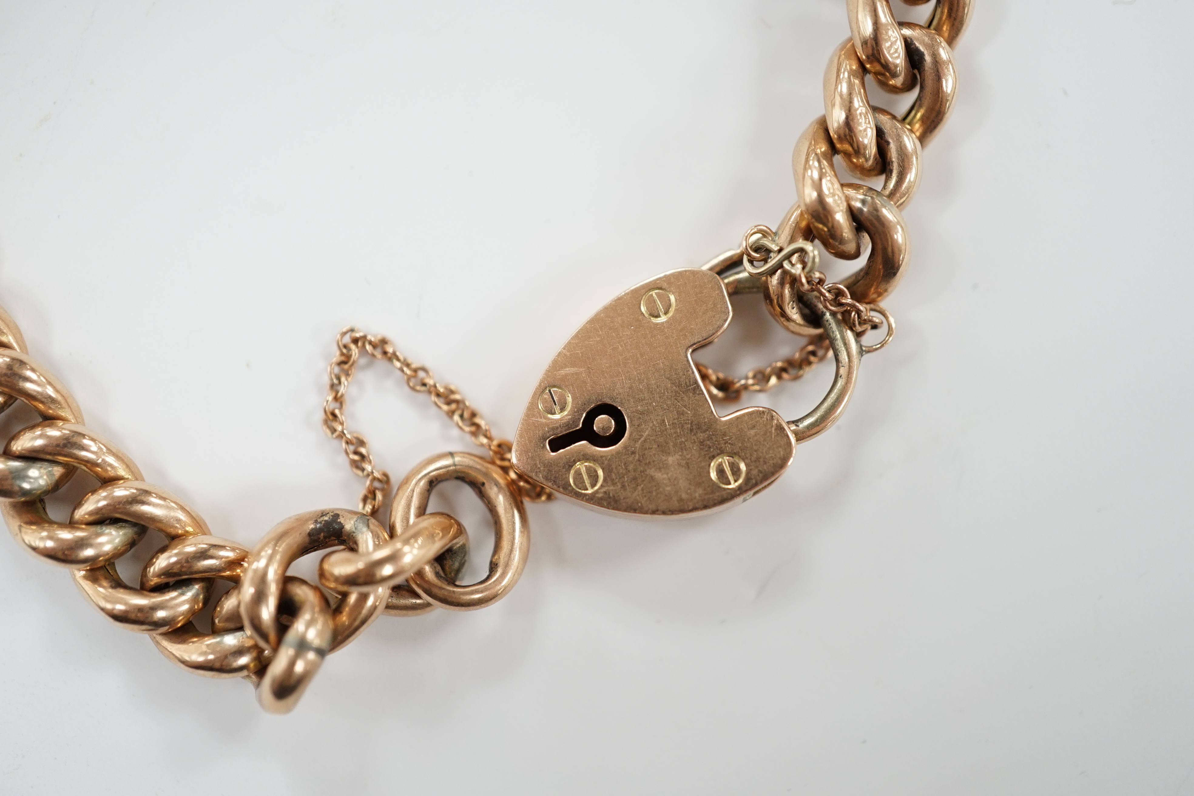 An Edwardian 9ct gold curb link bracelet, with heart shaped padlock clasp, 18cm